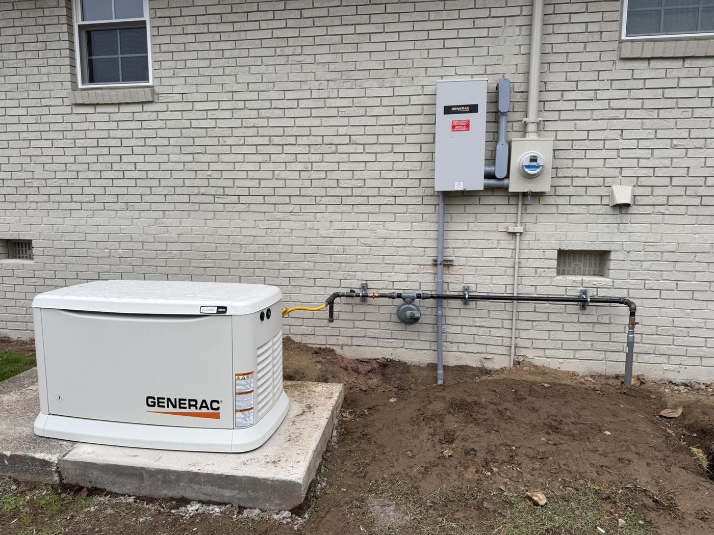 Generac standby generator beside a brick home